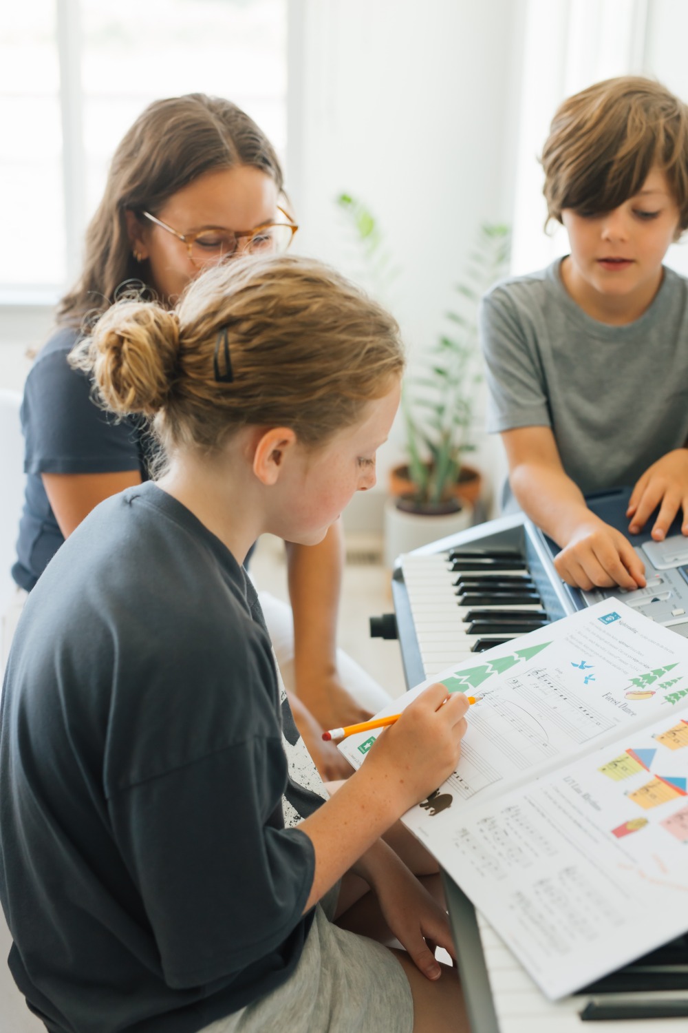Siblings learning piano together